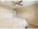 Bright bedroom features a ceiling fan, neutral walls, tile floors, and a large closet at 2817 La Mancha Ct, Punta Gorda, FL 33950