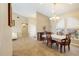 Open concept with dining room and living room, with an elegant chandelier over the dining table at 2817 La Mancha Ct, Punta Gorda, FL 33950