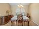 Elegant dining room with a decorative chandelier and large windows, complemented by a dark wood buffet at 2817 La Mancha Ct, Punta Gorda, FL 33950