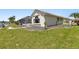 Lush backyard with manicured lawn, rock gardens, and covered lanai at 2817 La Mancha Ct, Punta Gorda, FL 33950