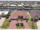 Beautiful waterfront home with a terracotta-colored roof and brick driveway lined with palm trees and canal views at 2817 La Mancha Ct, Punta Gorda, FL 33950