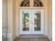 Close up of front double doors with glass inserts leading to the home's entryway at 2817 La Mancha Ct, Punta Gorda, FL 33950