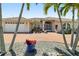 Attractive single-story home with a brick driveway and lush tropical landscaping surrounding the property at 2817 La Mancha Ct, Punta Gorda, FL 33950