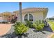 Inviting front exterior featuring a tiled roof, rock garden, and well-maintained landscaping at 2817 La Mancha Ct, Punta Gorda, FL 33950