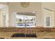 Well-equipped kitchen featuring granite countertops and a view of the inviting pool area at 2817 La Mancha Ct, Punta Gorda, FL 33950