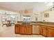 Modern kitchen featuring wood cabinetry and stainless steel appliances, adjacent to the dining area at 2817 La Mancha Ct, Punta Gorda, FL 33950