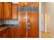 Kitchen with granite countertops, wood cabinets, and stainless steel refrigerator at 2817 La Mancha Ct, Punta Gorda, FL 33950