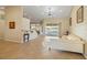 Bright living room with tile flooring, offering a view of the pool through sliding glass doors at 2817 La Mancha Ct, Punta Gorda, FL 33950