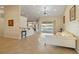 Bright living room with tile flooring, offering a view of the pool through sliding glass doors at 2817 La Mancha Ct, Punta Gorda, FL 33950