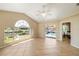 Bright living room featuring tile flooring, sliding glass doors, and a large arched window overlooking the canal and pool at 2817 La Mancha Ct, Punta Gorda, FL 33950