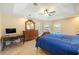 Spacious main bedroom with a fan, ensuite bath, and access to a walkout to a pool at 2817 La Mancha Ct, Punta Gorda, FL 33950