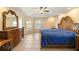 Main bedroom with tile floors, ceiling fan, and a large dresser at 2817 La Mancha Ct, Punta Gorda, FL 33950
