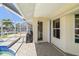Outdoor patio with tiled floor, covered grill, pool access, and convenient half bathroom access at 2817 La Mancha Ct, Punta Gorda, FL 33950