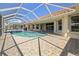 Screened in pool is surrounded by tile and has an attached spa at 2817 La Mancha Ct, Punta Gorda, FL 33950