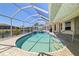 Private pool with clear blue water, tiled surround, and a screened enclosure at 2817 La Mancha Ct, Punta Gorda, FL 33950