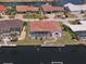 Waterfront home featuring a screened-in pool and dock overlooking the canal, providing the perfect outdoor retreat at 2817 La Mancha Ct, Punta Gorda, FL 33950