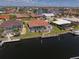 Aerial view of a waterfront home featuring a screened pool and dock along the canal, perfect for relaxation and entertainment at 2817 La Mancha Ct, Punta Gorda, FL 33950