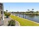 Picturesque waterfront view with manicured lawn and boat dock, offering serene water access at 2817 La Mancha Ct, Punta Gorda, FL 33950