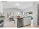 Open concept kitchen with granite countertops, island, and stainless steel dishwasher overlooking the living room at 287 Biltmore St, Port Charlotte, FL 33953