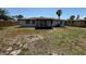 The home's backyard features a screened-in patio with a ceiling fan and ample space at 2919 Bayshore Gardens Pkwy, Bradenton, FL 34207