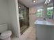 Bathroom with glass enclosed shower, marble vanity, and updated fixtures at 2919 Bayshore Gardens Pkwy, Bradenton, FL 34207