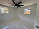 Bright bedroom with modern ceiling fan, and marble tile flooring at 2919 Bayshore Gardens Pkwy, Bradenton, FL 34207