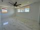 Spacious bedroom featuring a modern ceiling fan and marble-look tile flooring at 2919 Bayshore Gardens Pkwy, Bradenton, FL 34207