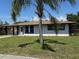 Well-maintained home with a palm tree in the front yard and freshly painted exterior at 2919 Bayshore Gardens Pkwy, Bradenton, FL 34207