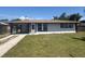Charming single-story home featuring a well-manicured lawn, covered carport, and freshly painted exterior at 2919 Bayshore Gardens Pkwy, Bradenton, FL 34207