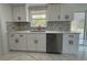 Beautiful kitchen with white cabinetry, modern appliances, and marble countertops at 2919 Bayshore Gardens Pkwy, Bradenton, FL 34207
