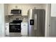 Updated kitchen features stainless steel appliances and stylish tile backsplash at 2919 Bayshore Gardens Pkwy, Bradenton, FL 34207