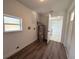Spacious laundry room with water heater, window, and wood look flooring at 2919 Bayshore Gardens Pkwy, Bradenton, FL 34207