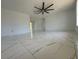 Spacious living room with modern marble flooring, a ceiling fan, and plenty of natural light at 2919 Bayshore Gardens Pkwy, Bradenton, FL 34207