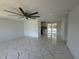 Spacious living room with modern marble flooring, a ceiling fan, and plenty of natural light at 2919 Bayshore Gardens Pkwy, Bradenton, FL 34207