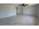 Spacious living room with modern marble flooring, a ceiling fan, and plenty of natural light at 2919 Bayshore Gardens Pkwy, Bradenton, FL 34207
