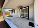 Covered patio with neutral tile and a fan, accessible through sliding glass doors at 2919 Bayshore Gardens Pkwy, Bradenton, FL 34207