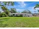 The back of the house features a large yard and patio, with plenty of room for entertaining at 320 25Th W St, Bradenton, FL 34205