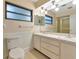 Well-lit bathroom featuring double vanities, a large mirror, and a separate shower, offering a functional space at 320 25Th W St, Bradenton, FL 34205