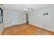This empty bedroom has hardwood floors, a window and two white doors at 320 25Th W St, Bradenton, FL 34205