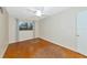 Empty bedroom featuring wood flooring, a ceiling fan, and a window with curtains at 320 25Th W St, Bradenton, FL 34205