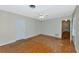 Bedroom with neutral walls, parquet floors, ceiling fan and convenient access to nearby rooms at 320 25Th W St, Bradenton, FL 34205
