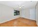 An empty bedroom with hardwood floors, a window, and a white closet door at 320 25Th W St, Bradenton, FL 34205