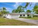 Spacious home with an attached garage, a large driveway, and mature landscaping at 320 25Th W St, Bradenton, FL 34205
