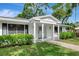 Attractive front entrance with columns and lush greenery adds to the curb appeal at 320 25Th W St, Bradenton, FL 34205