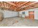Spacious garage with exposed wood beams, work bench, and cabinets at 320 25Th W St, Bradenton, FL 34205