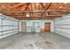 Spacious garage with exposed wood beams, work bench, and cabinets at 320 25Th W St, Bradenton, FL 34205