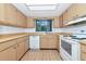 Functional kitchen featuring classic wood cabinets, tile backsplash, and modern appliances, providing a cozy space to prepare meals at 320 25Th W St, Bradenton, FL 34205