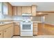 Traditional kitchen with wood cabinets, white appliances, and practical layout, blending style and functionality at 320 25Th W St, Bradenton, FL 34205