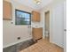 Bright laundry room with a sink, window, and direct access to a bathroom at 320 25Th W St, Bradenton, FL 34205