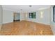 Open living room with parquet flooring, neutral walls, and stylish wall sconces, offering a versatile space at 320 25Th W St, Bradenton, FL 34205